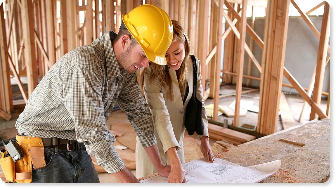 Builder and client looking at plans at construction site